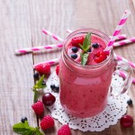 Smoothie with summer berries and fruits in a glass mug